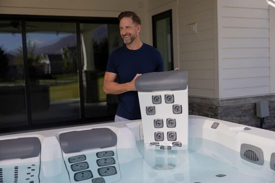 Removable jetted seat module being placed into a hot tub seat